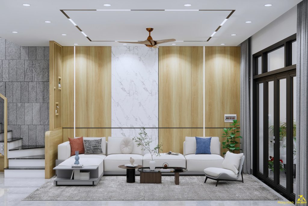 Không gian phòng khách sử dụng sofa chữ L màu trắng kem và gối nhấn màu trung tính tạo cảm giác thoải mái, trang nhã